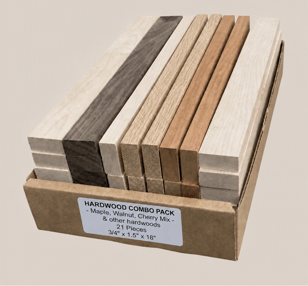A cardboard box containing a hardwood combo pack with multiple rectangular wood strips in different natural tones, including light beige, medium brown, and dark charcoal. A white label on the front reads 'HARDWOOD COMBO PACK - Maple, Walnut, Cherry Mix - 21 Pieces 3/4" x 1.